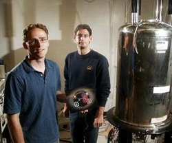 Scientists Tom Lowry (left) and Leif Schroeder stand next to a super conducting magnet. (Dean Coppola - MediaNews)