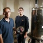 Scientists Tom Lowry (left) and Leif Schroeder stand next to a super conducting magnet. (Dean Coppola - MediaNews)